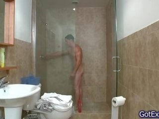 Λαμπρός μυώδης άνθρωπος τραβώντας μαλακία υπό μπάνιο